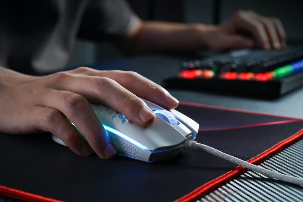 a person using a gaming mouse on a mouse pad.